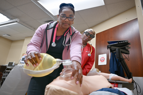 Ann Woods (left) conducts her quarterly Resuscitation Quality Improvement training as Theresa Turner (right) observes the exercise.